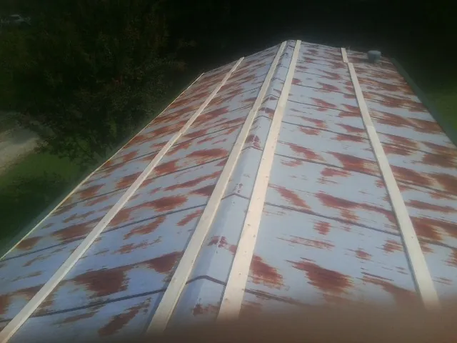Rusted metal roof panels with new wood purlins before replacement — Storm Damage Roof Repair in Pursglove by Roofing Brothers